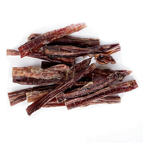 A pile of dried meat sticks on a white background